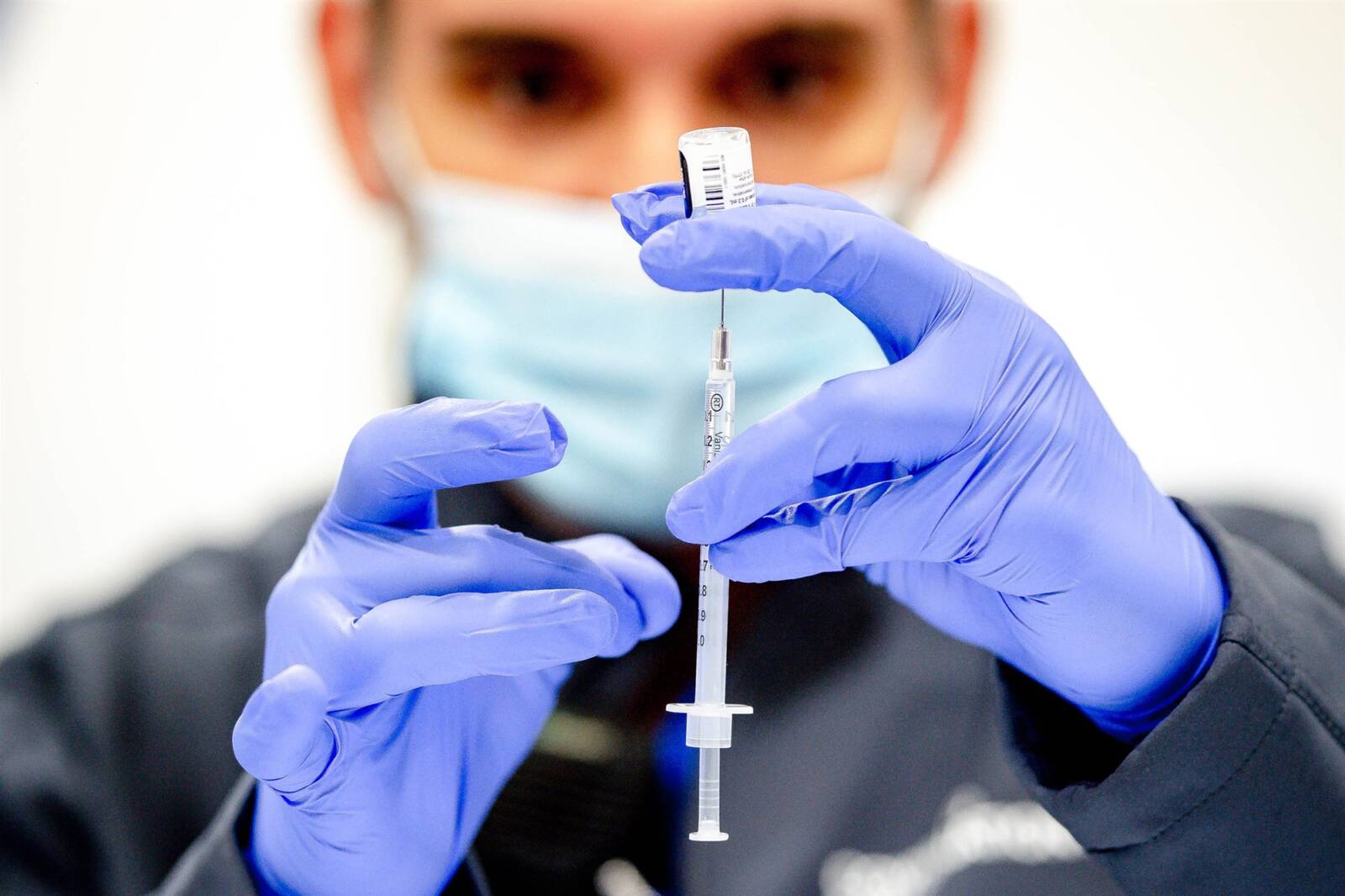 A pharmacist prepares a Covid-19 vaccine at Cal Poly Pomona in Pomona, Calif